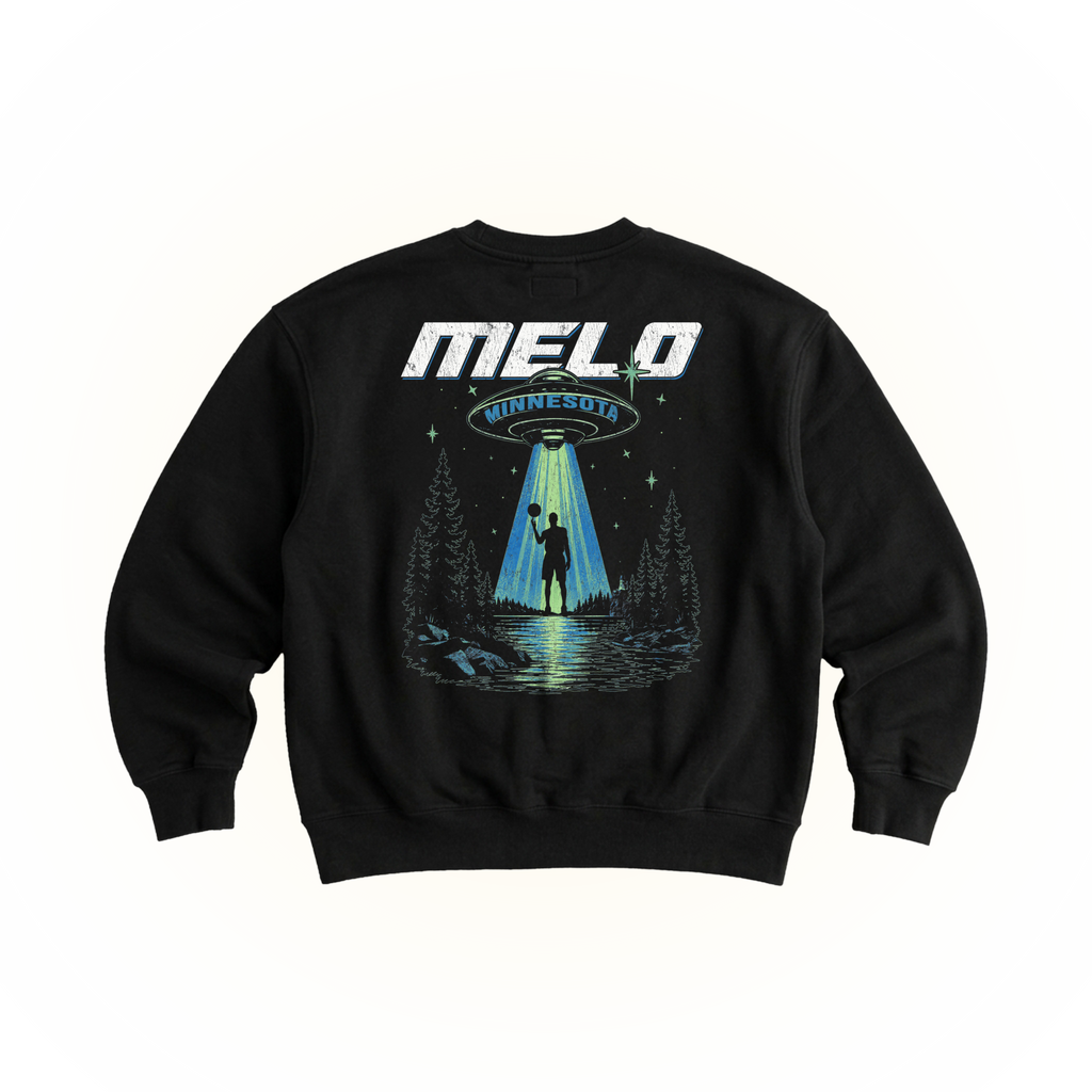 A black crewneck sweatshirt featuring a large graphic print on the front. The graphic displays the text 'MELO MINNESOTA' in white and blue, above an illustration of a UFO sending a beam of light to a silhouetted figure standing in a forest by a lake.