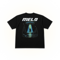 The back side of a black comfort colors tshirt featuring a large graphic print on the back. The graphic displays the text 'MELO MINNESOTA' in white and blue, above an illustration of a UFO sending a beam of light to a silhouetted figure standing in a forest by a lake.