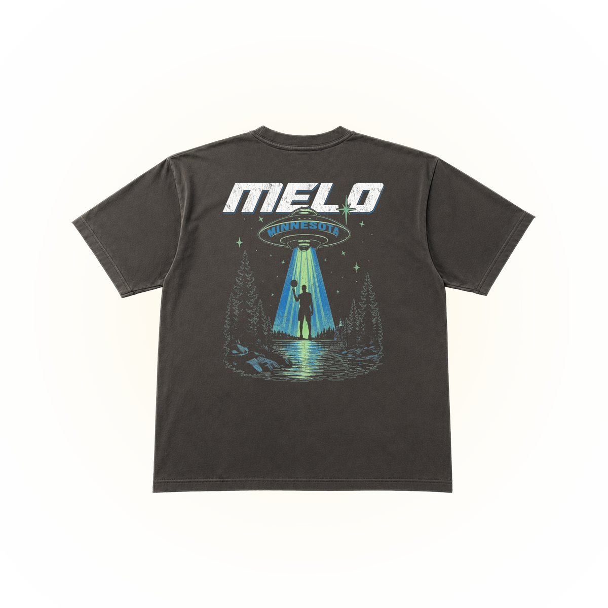 The back side of a pepper comfort colors tshirt featuring a large graphic print on the back. The graphic displays the text 'MELO MINNESOTA' in white and blue, above an illustration of a UFO sending a beam of light to a silhouetted figure standing in a forest by a lake.