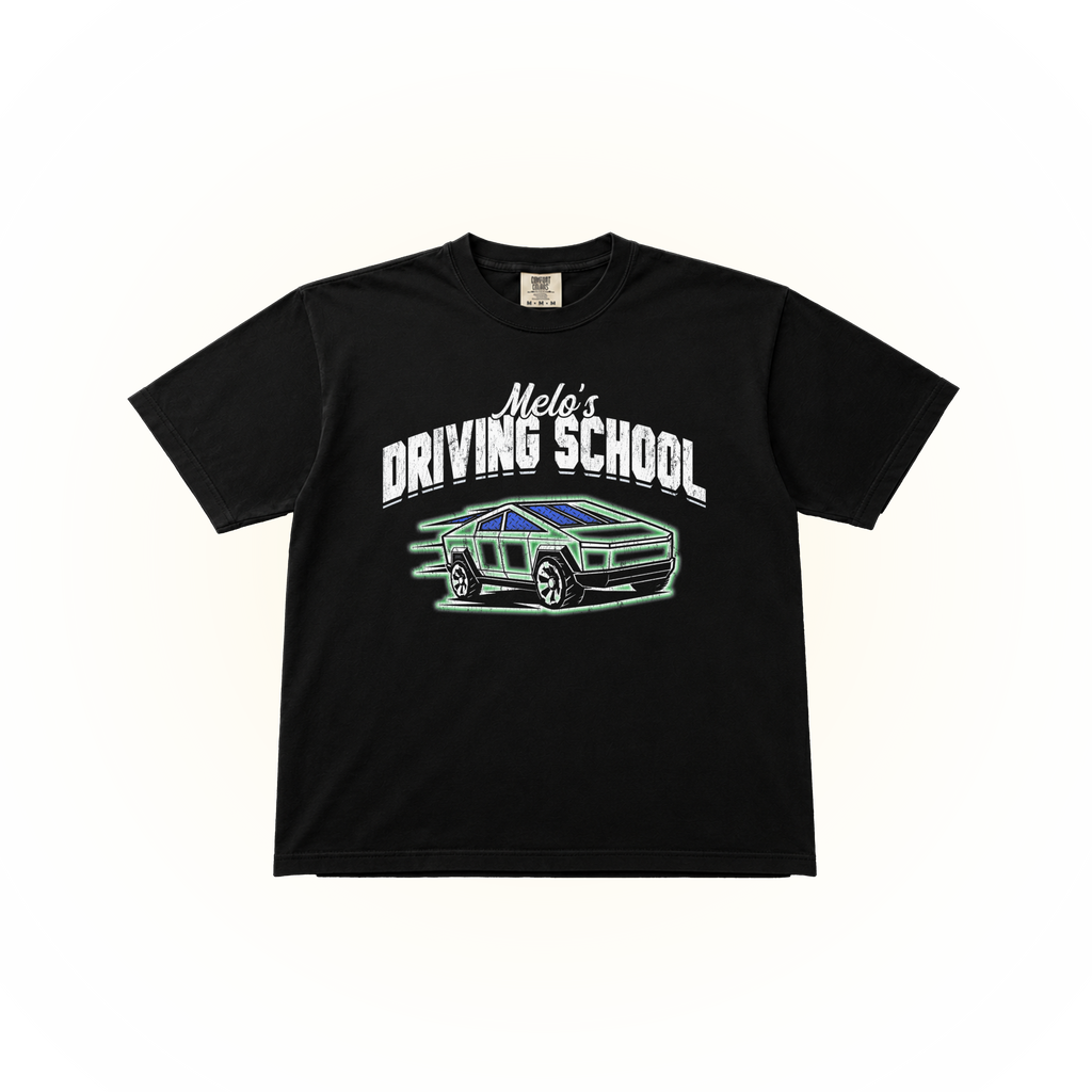 A black short-sleeve comfort colors graphic t-shirt featuring the text 'Melo's DRIVING SCHOOL' in white above a stylized green and blue car illustration, displayed flat against a solid white background.